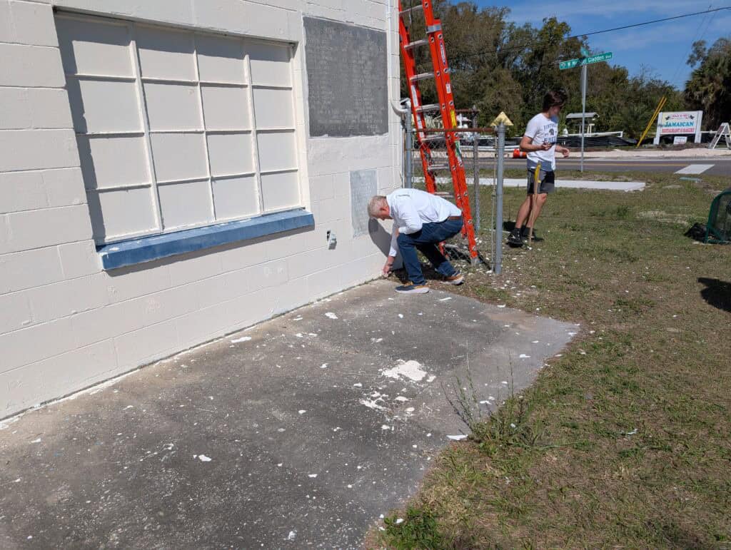 City of Apopka Mayor Bryan Nelson pulling weeds